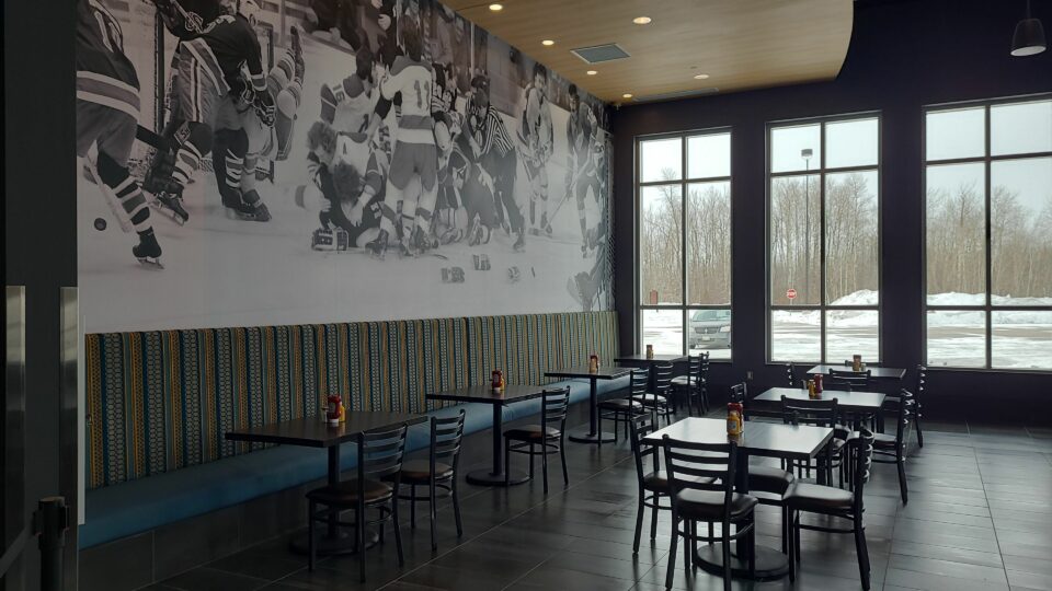 7. Pucks and Pints wall wrap of Hockey players